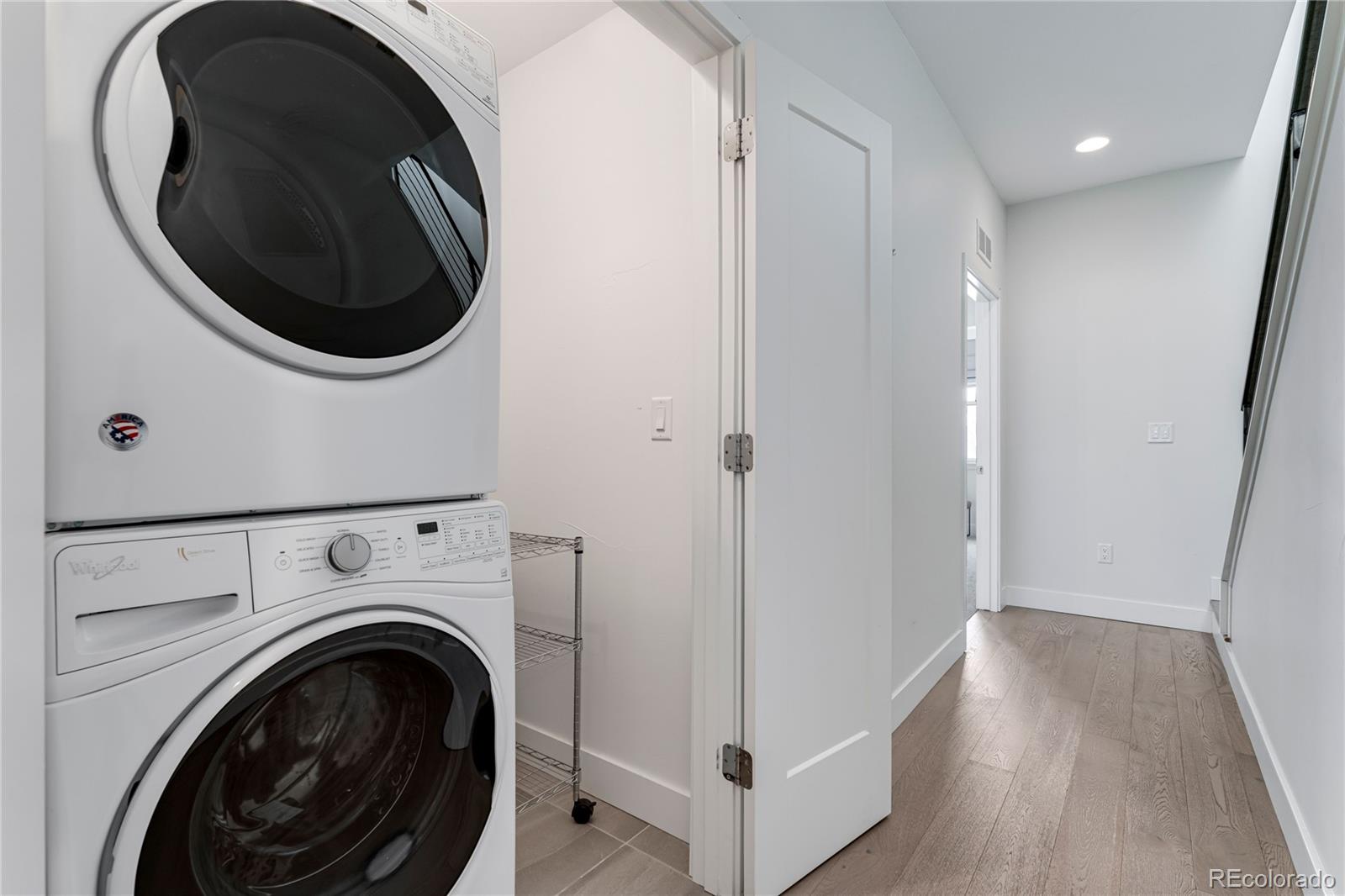 1587 Perry Street Denver, CO 80204 - Photo 14 of 37 a view of a hallway with washer and dryer
