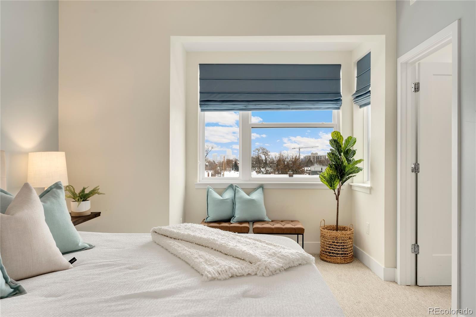 1587 Perry Street Denver, CO 80204 - Photo 19 of 37 a bed sitting in a spacious bedroom next to a window
