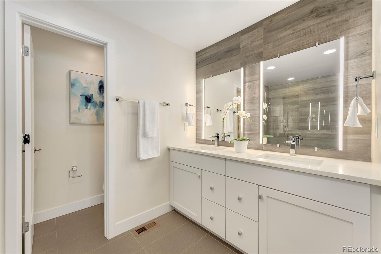 1587 Perry Street Denver, CO 80204 - Photo 21 of 37 a bathroom with a double vanity sink and mirror