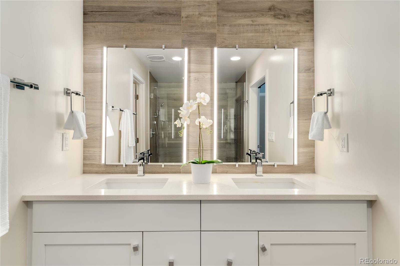 1587 Perry Street Denver, CO 80204 - Photo 22 of 37 a bathroom with double vanity sinks and a mirror
