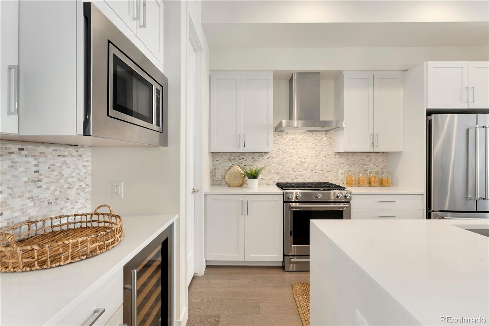 1587 Perry Street Denver, CO 80204 - Photo 5 of 37 a kitchen with a stove and a microwave