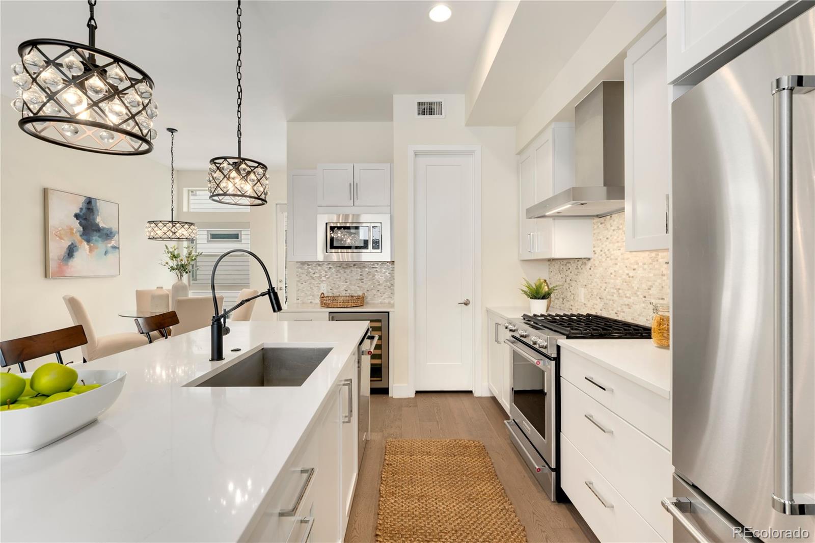 1587 Perry Street Denver, CO 80204 - Photo 7 of 37 a kitchen with stainless steel appliances granite countertop a sink stove and refrigerator