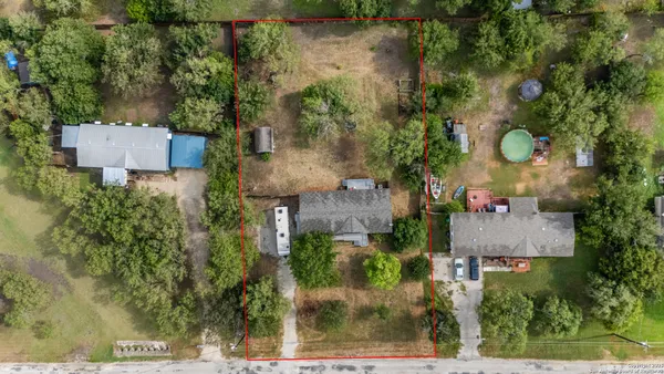 an aerial view of a house with a yard and garden