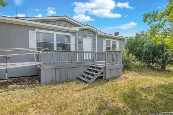 a view of a house with wooden fence
