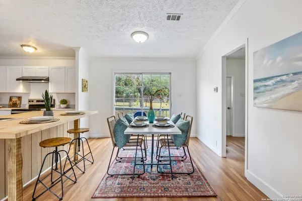 a view of a dining room with furniture window and wooden floor