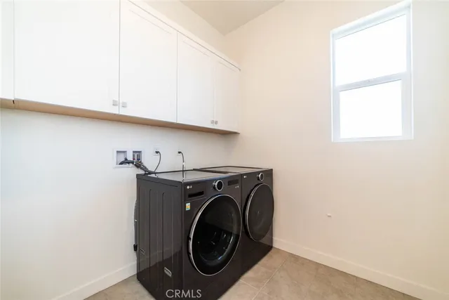a kitchen with stainless steel appliances white cabinets a stove and a microwave