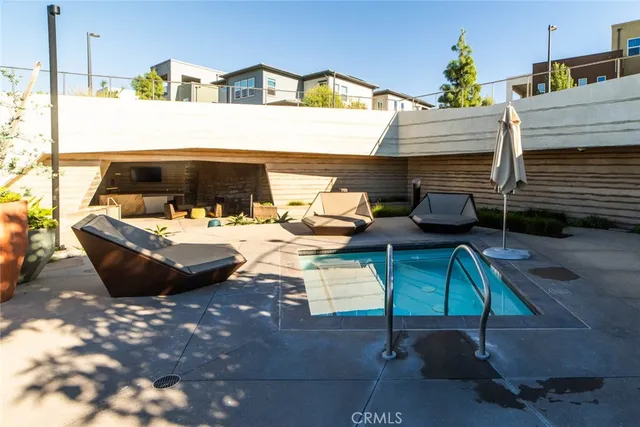 a roof deck with couches and city view