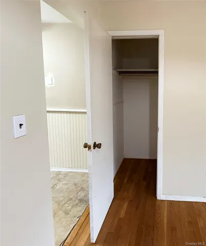 a brick house with trees in front of it