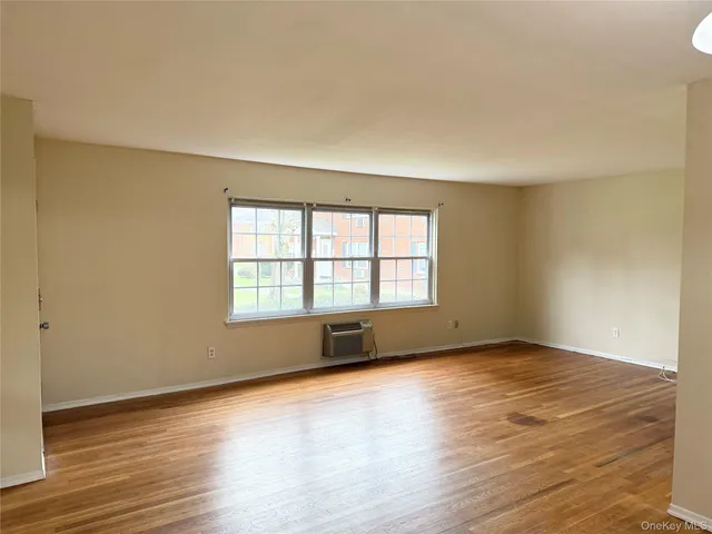 front view of a brick house with a yard
