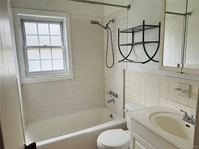 a bathroom with a sink a window and a shower