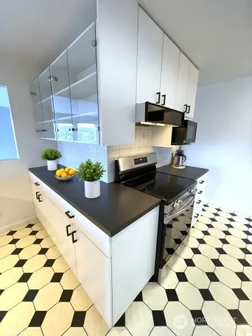 a view of a workspace with furniture and a potted plant