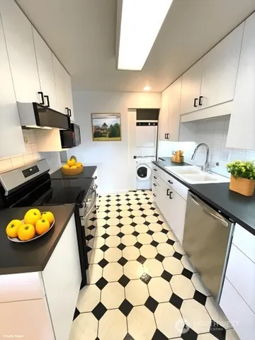 a bedroom with a bed window and a flat screen tv