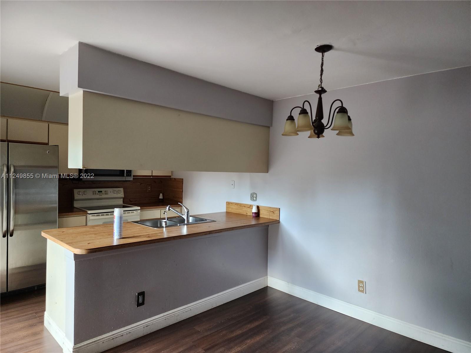 8139 Boca Rio Drive, Unit 8139 Boca Raton, FL 33433 - Photo 11 of 23 a room with a wooden floor and white walls