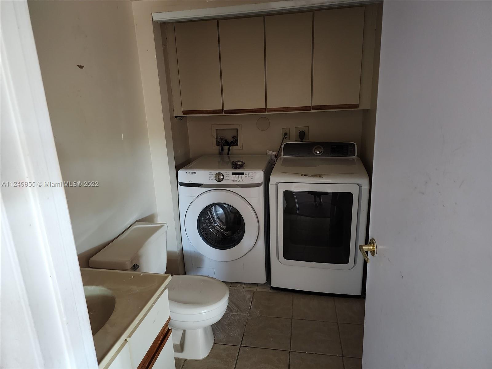 8139 Boca Rio Drive, Unit 8139 Boca Raton, FL 33433 - Photo 13 of 23 a utility room with dryer and washer