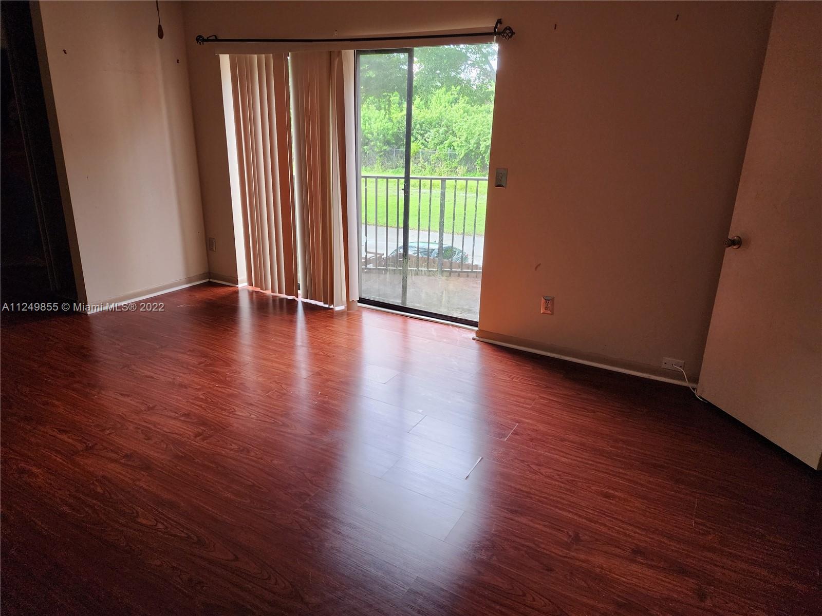 8139 Boca Rio Drive, Unit 8139 Boca Raton, FL 33433 - Photo 17 of 23 a view of a room with wooden floor and a window