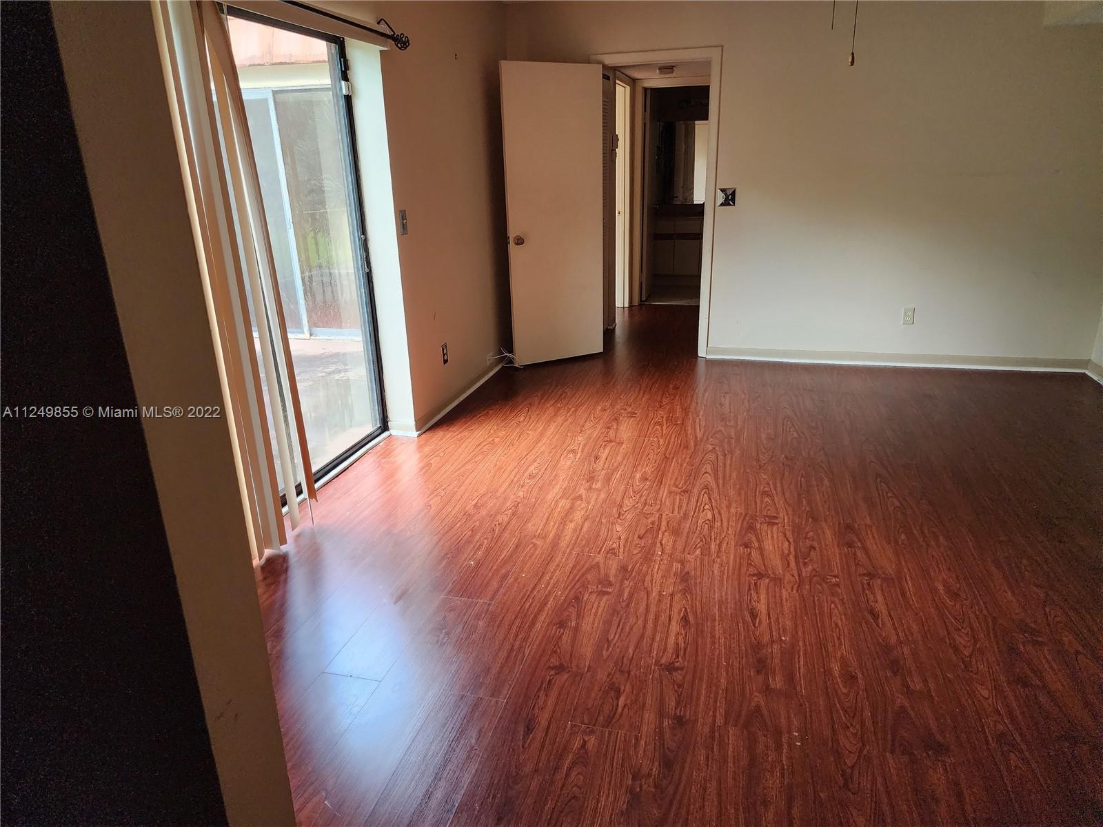 8139 Boca Rio Drive, Unit 8139 Boca Raton, FL 33433 - Photo 18 of 23 an empty room with wooden floor and stairs