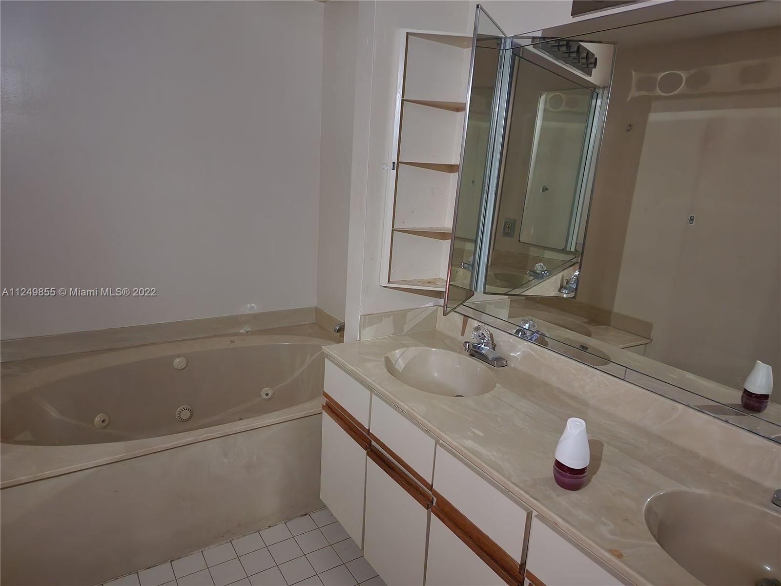 8139 Boca Rio Drive, Unit 8139 Boca Raton, FL 33433 - Photo 19 of 23 a bathroom with a sink and a mirror