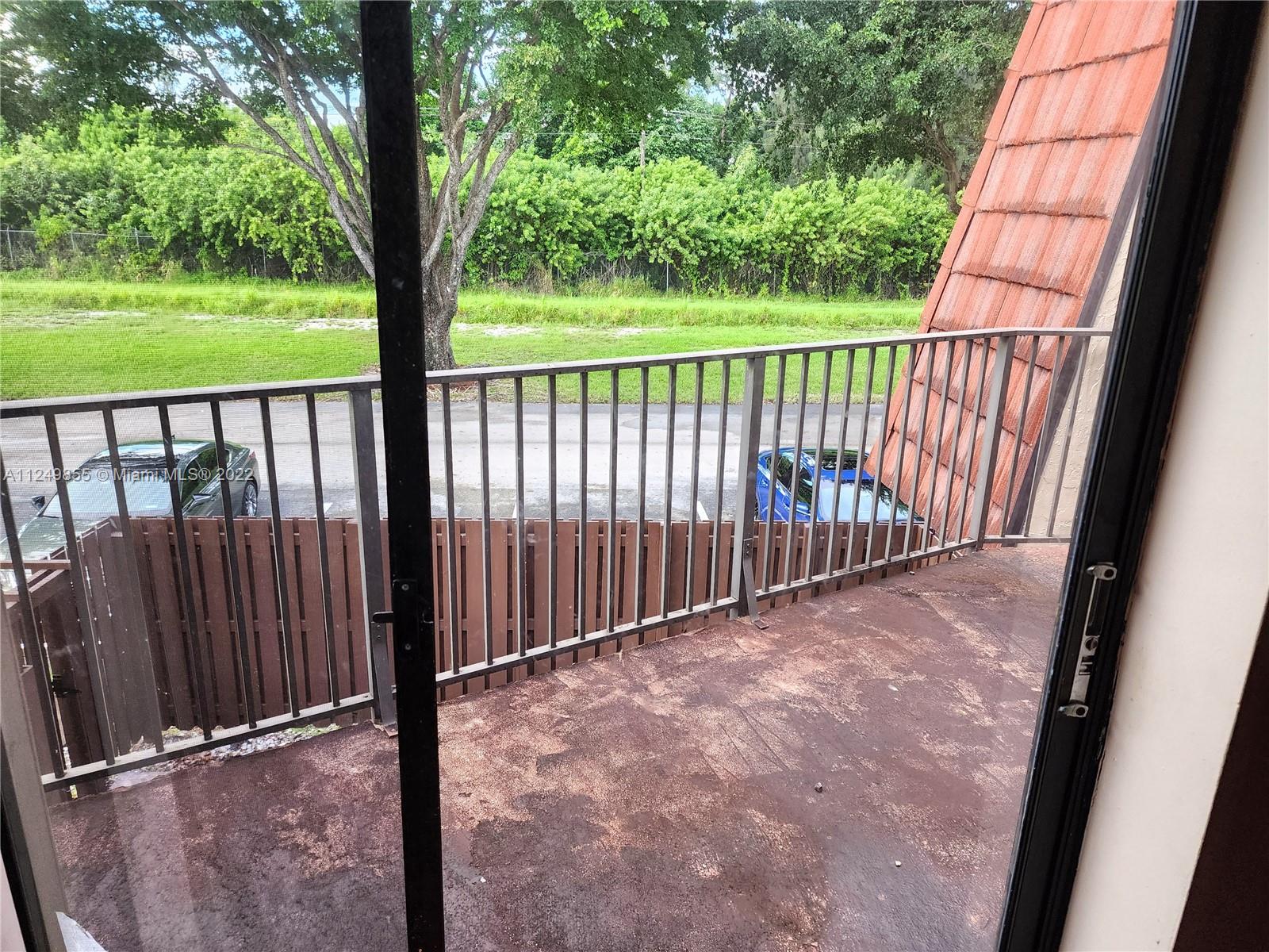 8139 Boca Rio Drive, Unit 8139 Boca Raton, FL 33433 - Photo 22 of 23 a view of balcony with wooden floor and fence