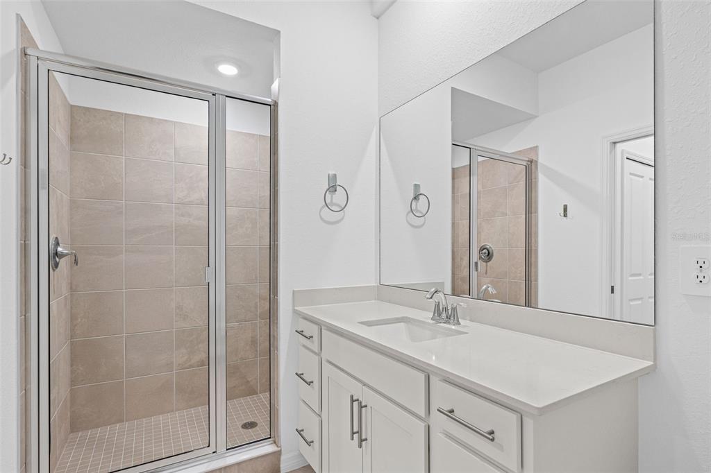 19140 Scallop Loop, Unit 401 Bradenton, FL 34211 - Photo 17 of 52 a bathroom with a shower sink and mirror