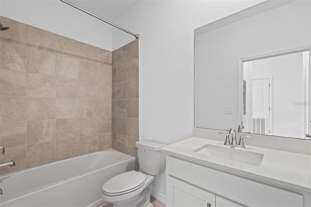 19140 Scallop Loop, Unit 401 Bradenton, FL 34211 - Photo 21 of 52 a bathroom with a sink a toilet and a bathtub