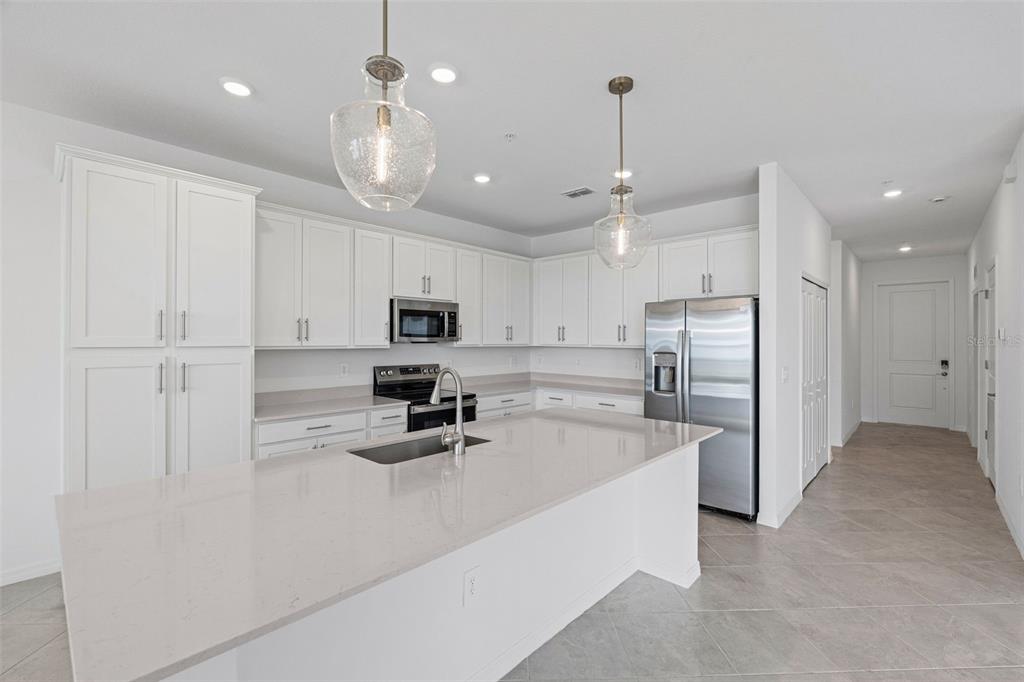 19140 Scallop Loop, Unit 401 Bradenton, FL 34211 - Photo 23 of 52 a kitchen with stainless steel appliances a refrigerator sink and microwave