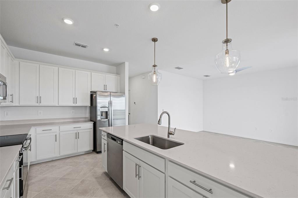 19140 Scallop Loop, Unit 401 Bradenton, FL 34211 - Photo 26 of 52 a kitchen with a sink stainless steel appliances and cabinets