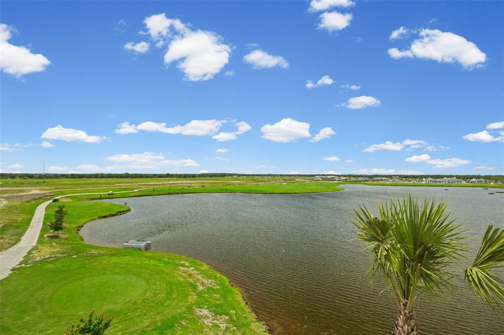 19140 Scallop Loop, Unit 401 Bradenton, FL 34211 - Photo 42 of 52 a view of a lake and a yard
