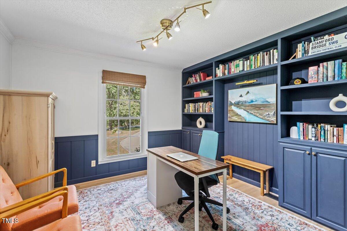 4912 Elizabeth Drive Raleigh, NC 27604 - Photo 11 of 35 a living room with furniture a rug and a book shelf