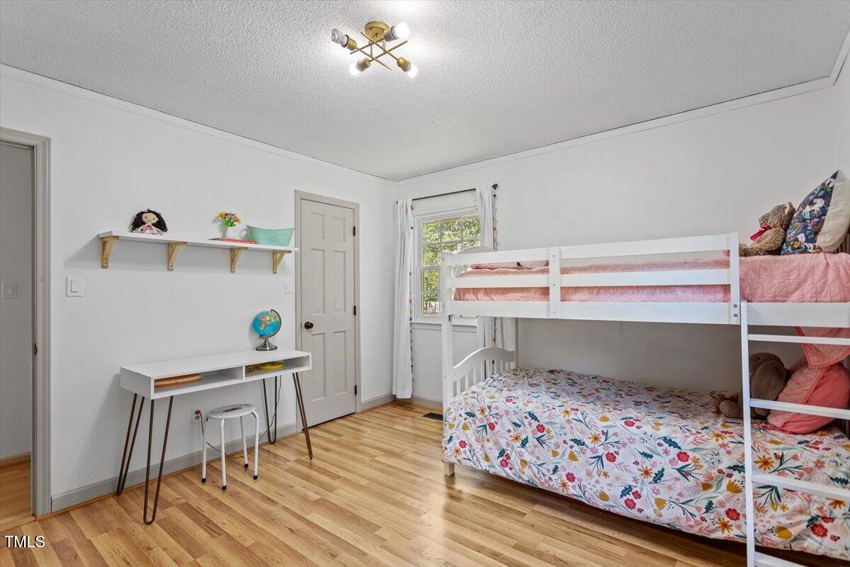 4912 Elizabeth Drive Raleigh, NC 27604 - Photo 20 of 35 a bedroom with a bed and a table in it