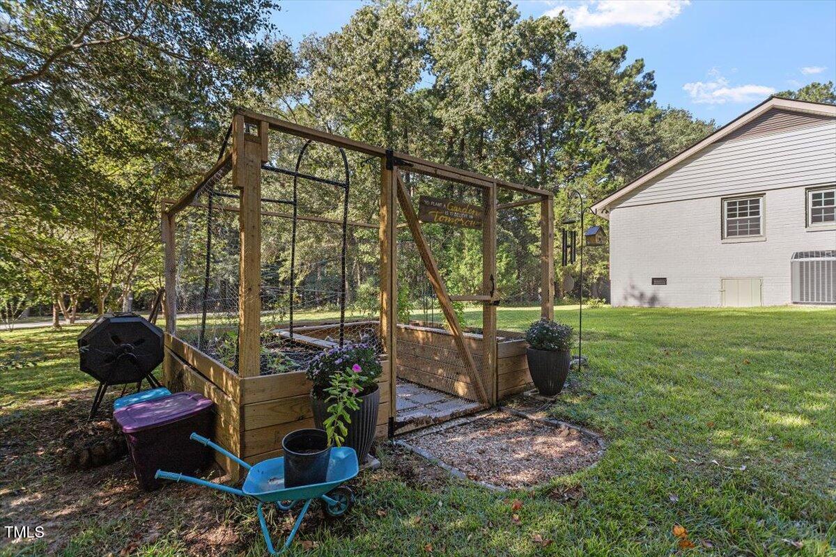 4912 Elizabeth Drive Raleigh, NC 27604 - Photo 29 of 35 a view of a backyard with couches potted plants and a large tree