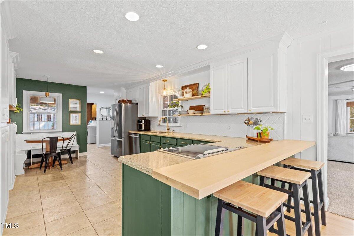 4912 Elizabeth Drive Raleigh, NC 27604 - Photo 7 of 35 a kitchen with a table and chairs in it