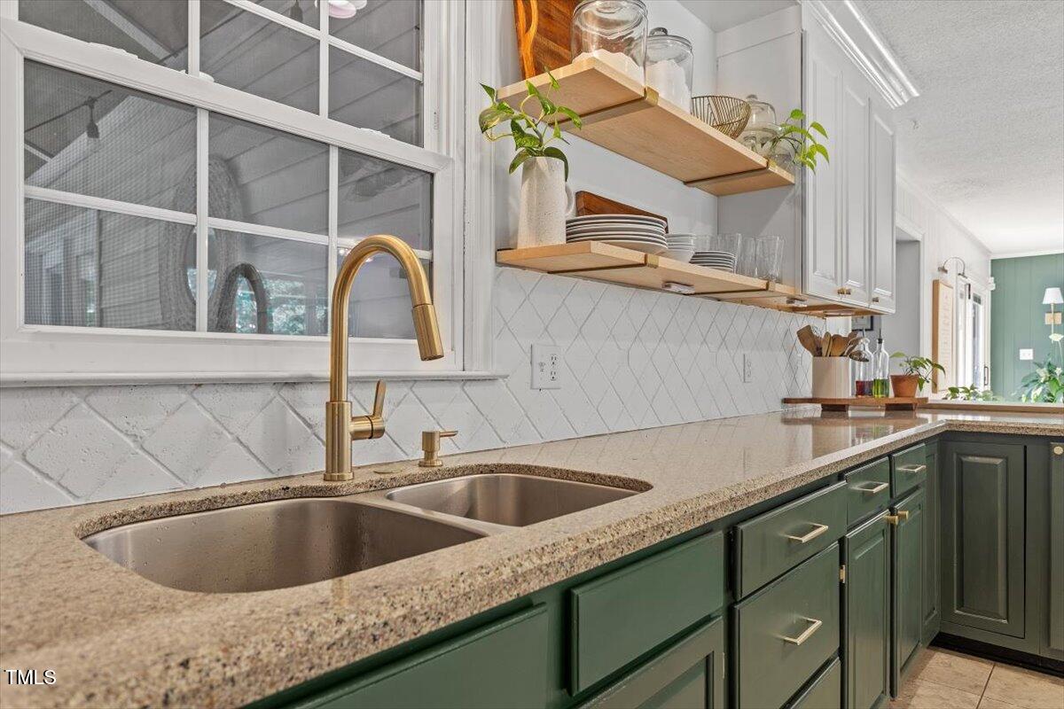 4912 Elizabeth Drive Raleigh, NC 27604 - Photo 9 of 35 a kitchen with a sink and a stove