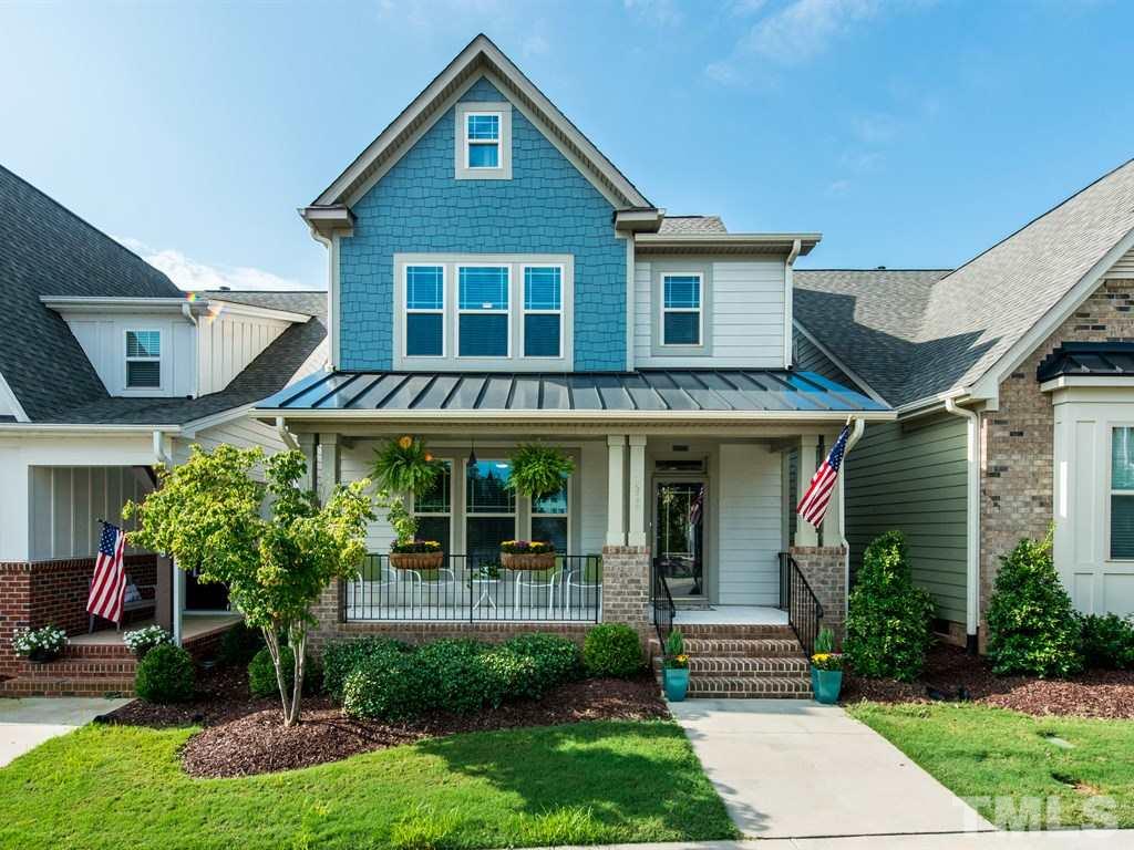1310 Rodessa Run Raleigh, NC 27607 - Photo 1 of 25 a front view of a house with a yard and potted plants