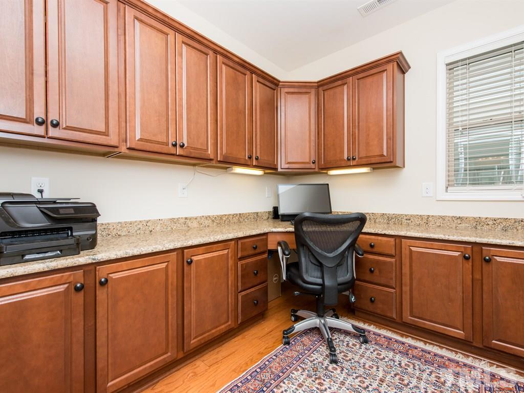 1310 Rodessa Run Raleigh, NC 27607 - Photo 12 of 25 a kitchen with stainless steel appliances granite countertop a stove a sink and a microwave