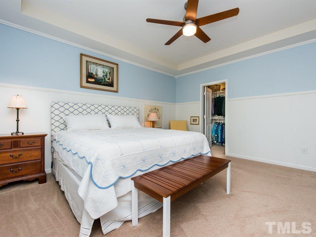 1310 Rodessa Run Raleigh, NC 27607 - Photo 14 of 25 a spacious bedroom with a bed and a chandelier