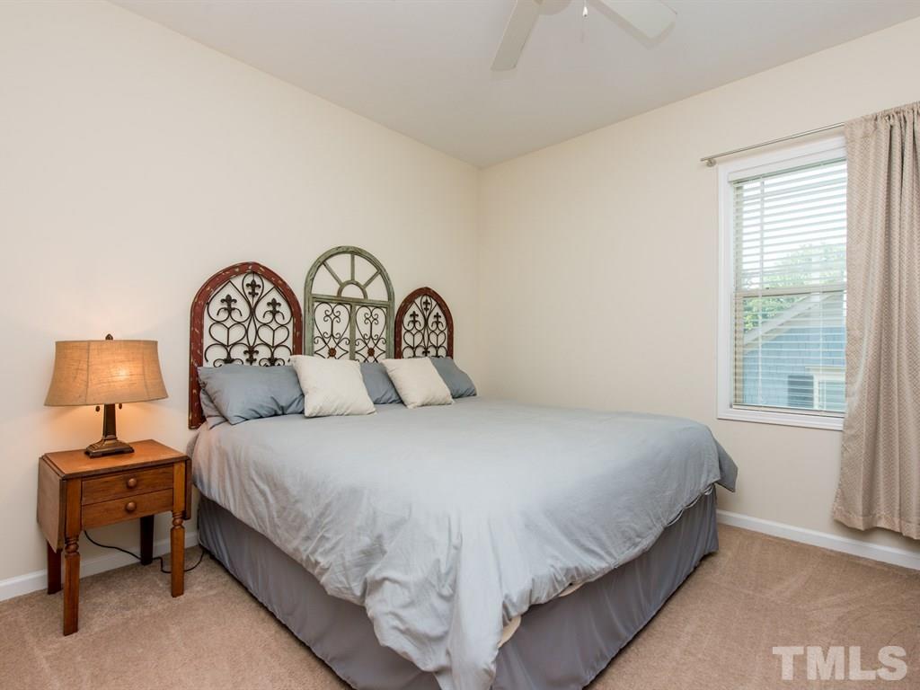 1310 Rodessa Run Raleigh, NC 27607 - Photo 17 of 25 a bedroom with a bed and a lamp