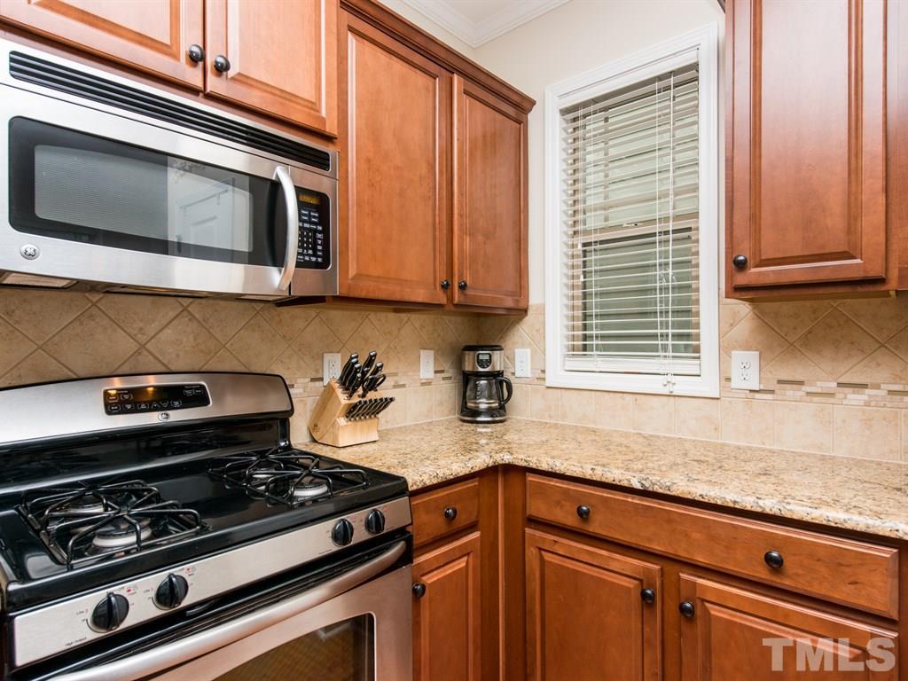 1310 Rodessa Run Raleigh, NC 27607 - Photo 5 of 25 a kitchen with granite countertop a stove and a sink