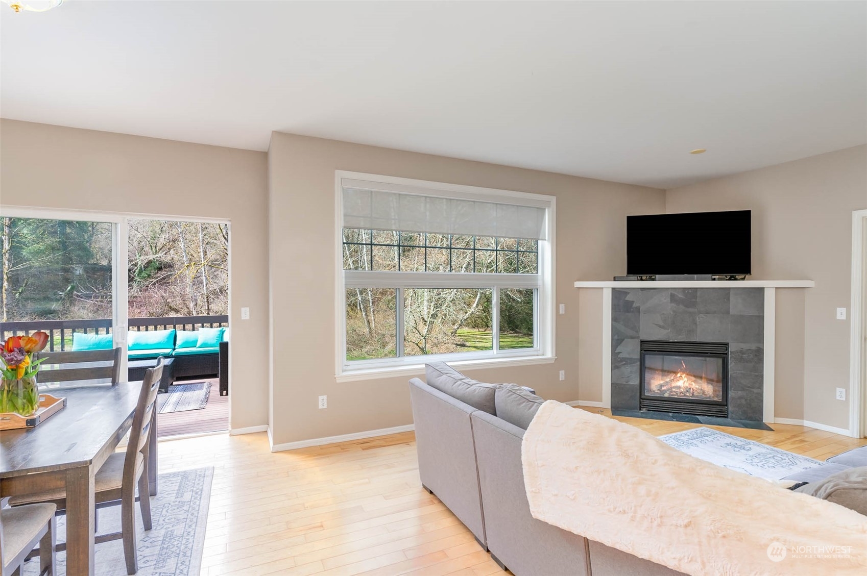 15503 Cedar Grove Road Southeast Issaquah, WA 98027 - Photo 11 of 27 a living room with furniture a flat screen tv and a fireplace