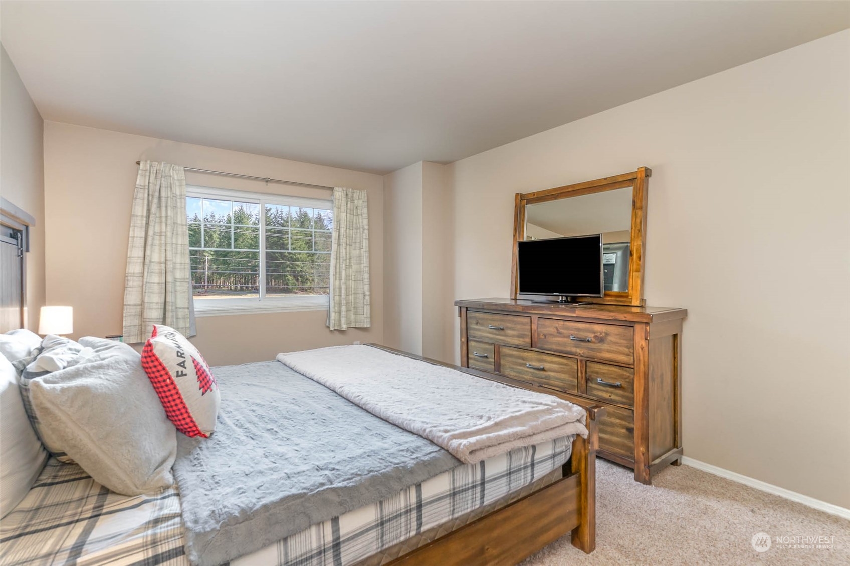 15503 Cedar Grove Road Southeast Issaquah, WA 98027 - Photo 15 of 27 a bedroom with a bed and a flat screen tv