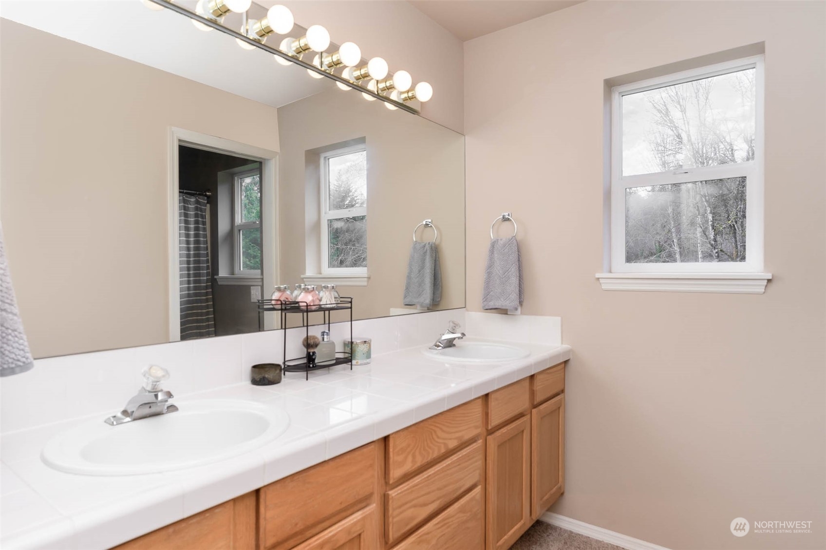 15503 Cedar Grove Road Southeast Issaquah, WA 98027 - Photo 16 of 27 a bathroom with double vanity and a mirror