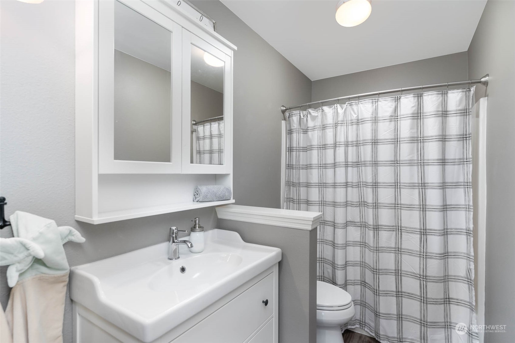 15503 Cedar Grove Road Southeast Issaquah, WA 98027 - Photo 20 of 27 a bathroom with a sink a toilet and shower curtain