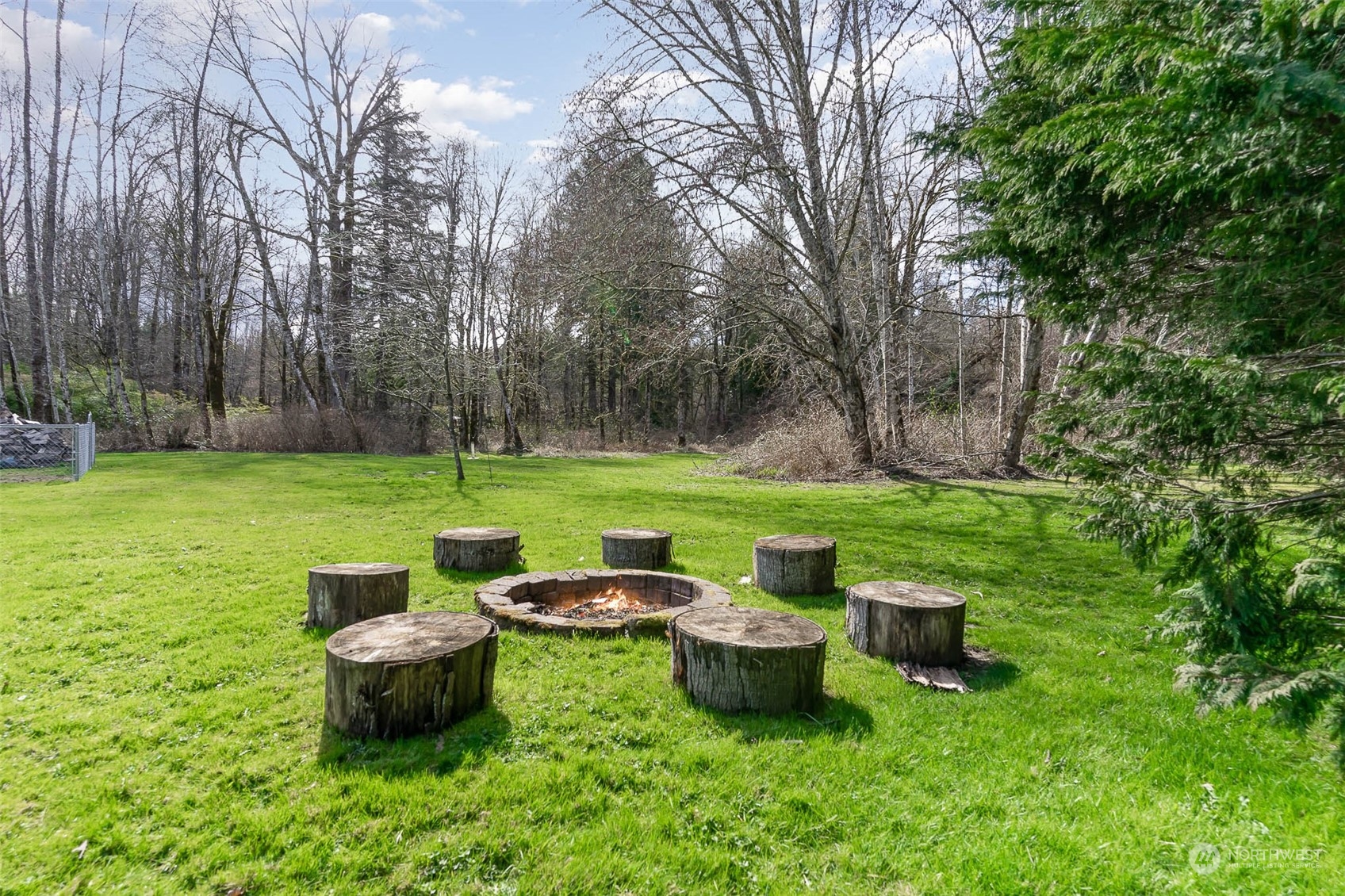 15503 Cedar Grove Road Southeast Issaquah, WA 98027 - Photo 22 of 27 a view of a backyard with lawn chairs and a fire pit