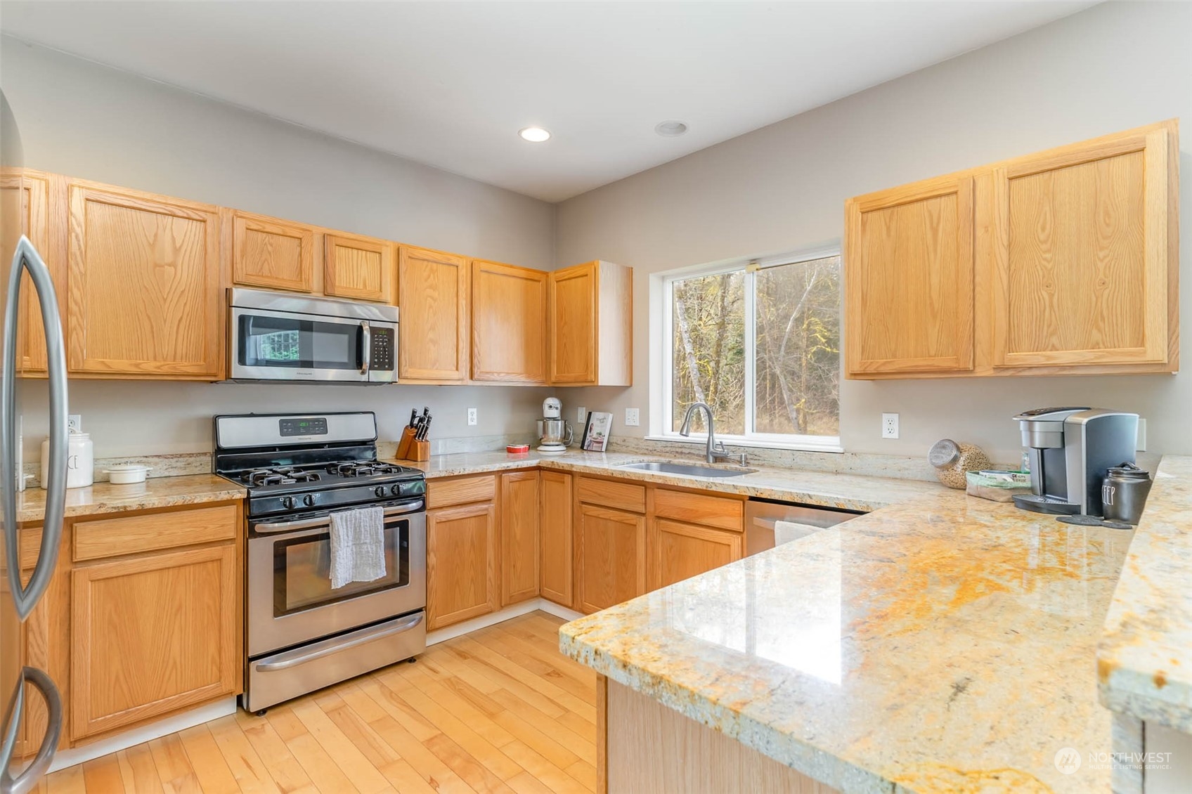 15503 Cedar Grove Road Southeast Issaquah, WA 98027 - Photo 8 of 27 a kitchen with stainless steel appliances granite countertop a stove a sink and a microwave