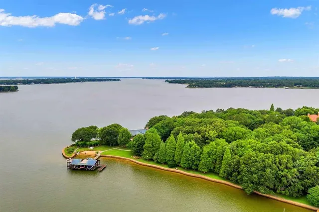 a lake view with boat and palm trees