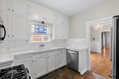 a kitchen with stainless steel appliances a refrigerator stove and microwave