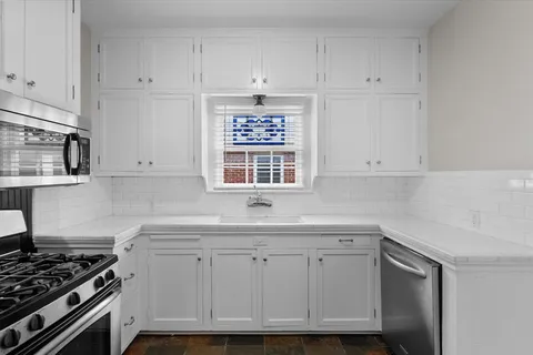 a kitchen with stainless steel appliances a refrigerator and a stove top oven
