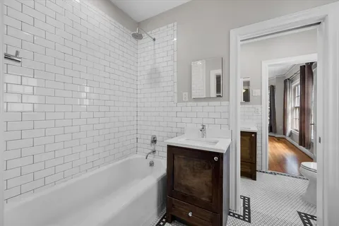 a bathroom with a shower and a sink