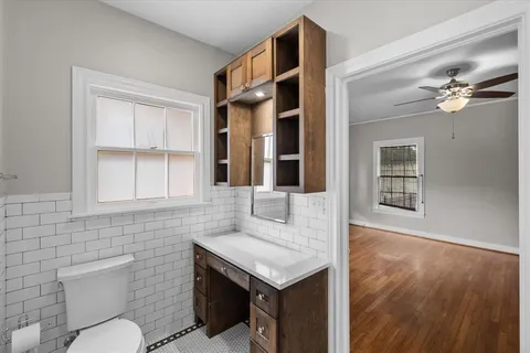 a bathroom with a sink vanity mirror and tub