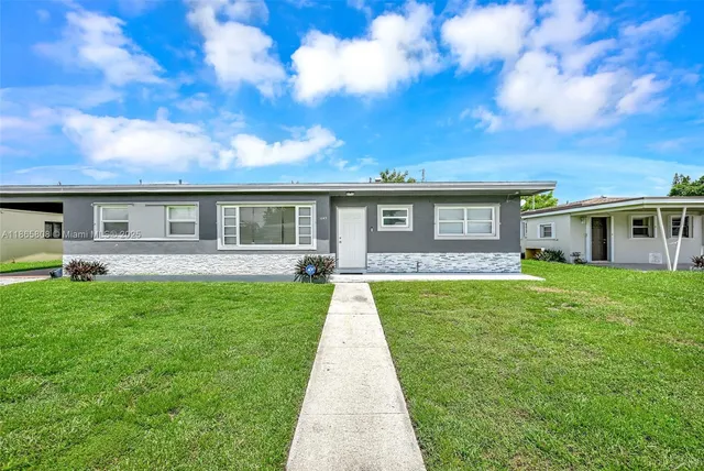 a view of a house with a backyard