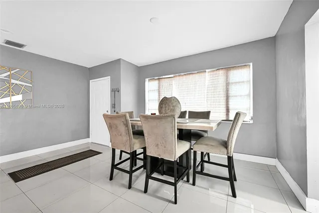 a view of a dining room with furniture and a window